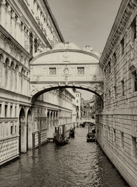 some bridges on water and buildings with boats on it