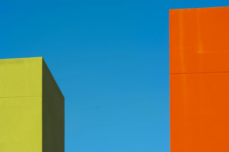 a couple of buildings that are painted orange and green