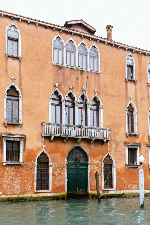 a large building has several open windows on it