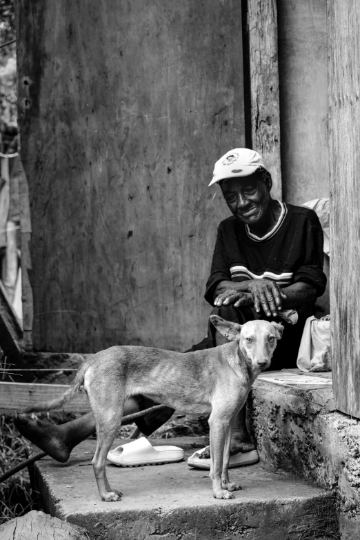 man and his dog on steps in front of a building