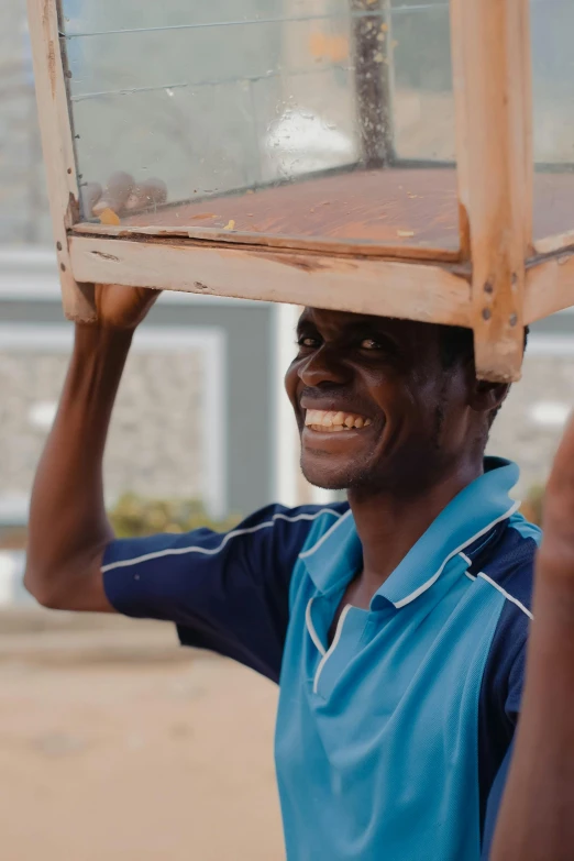 a person carries a box on their head