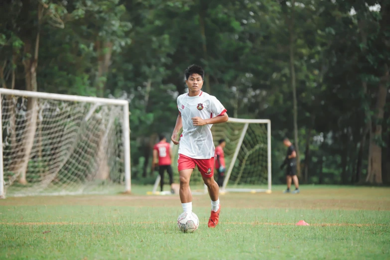 there is a male soccer player in a field playing