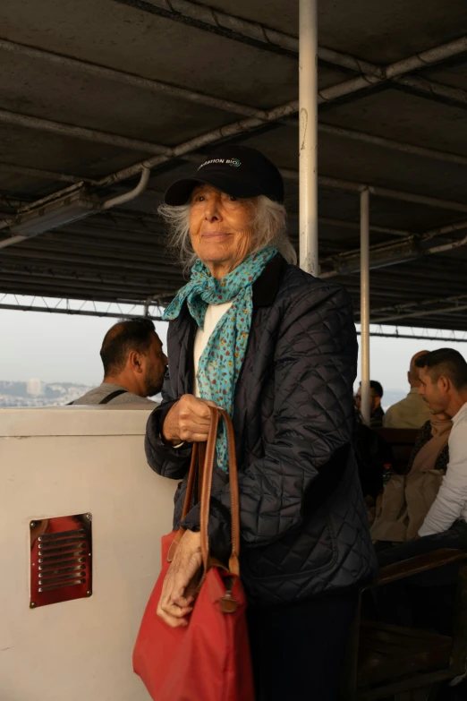 an older woman holding onto a red purse