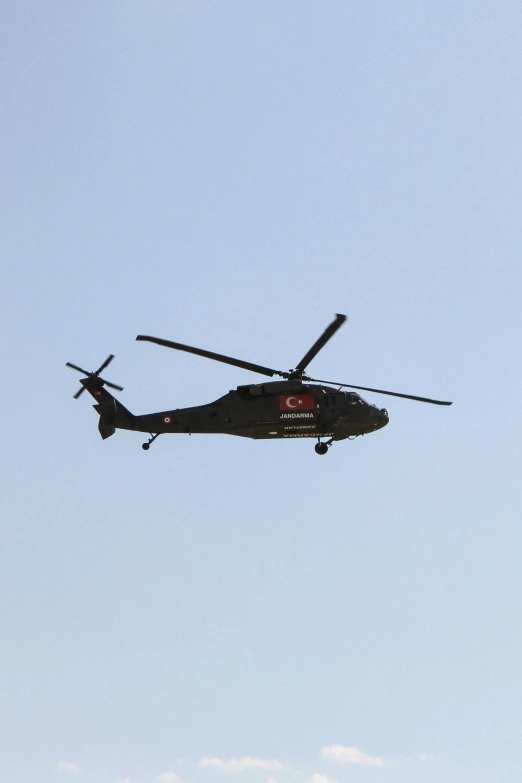 two large army style planes fly against the sky