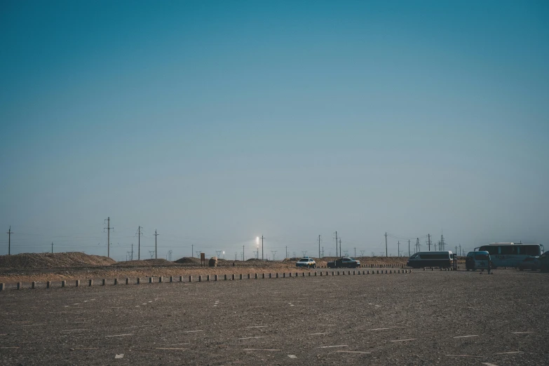 a field with an airplane flying in the sky