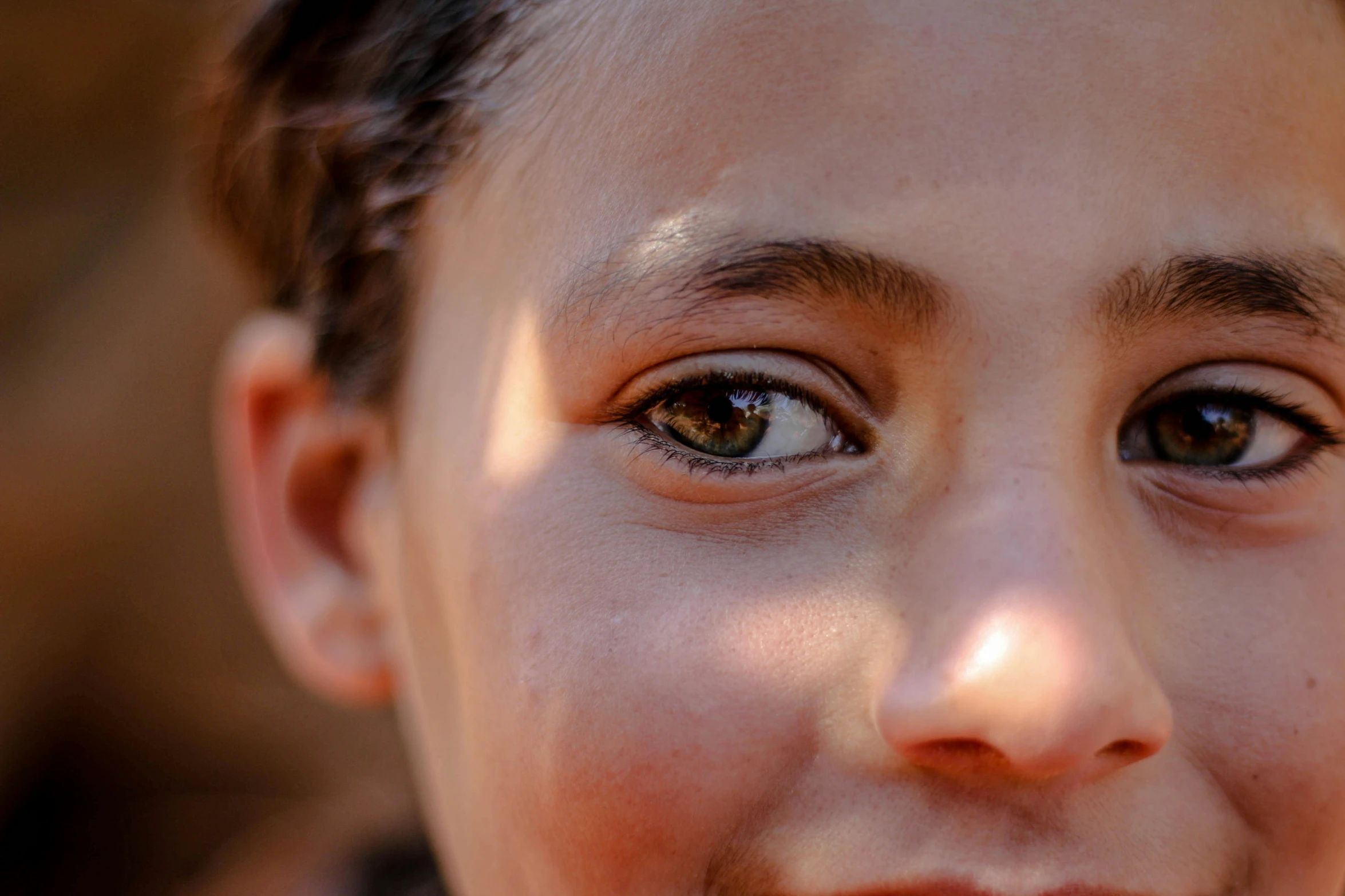 a close up view of a little girl's brown eyes