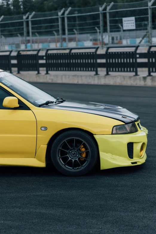 a yellow sports car parked on the track