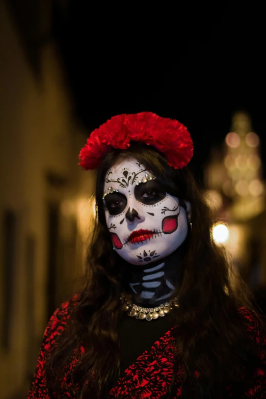 a woman in day of the dead makeup and face paint