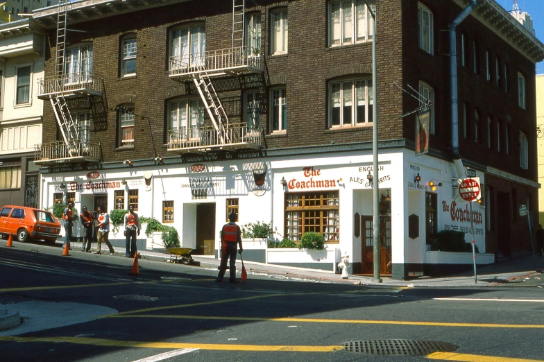 a brick building with ladders hanging off it's windows