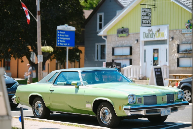 an old style car is parked on the side of the road