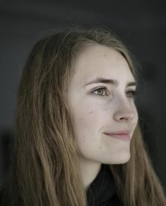 a woman with blue eyes posing for the camera