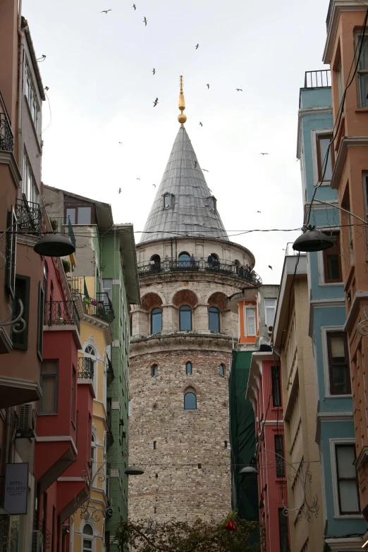 a large tower is shown through the narrow streets