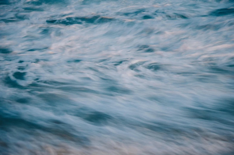 waves on a large body of water in blue hue