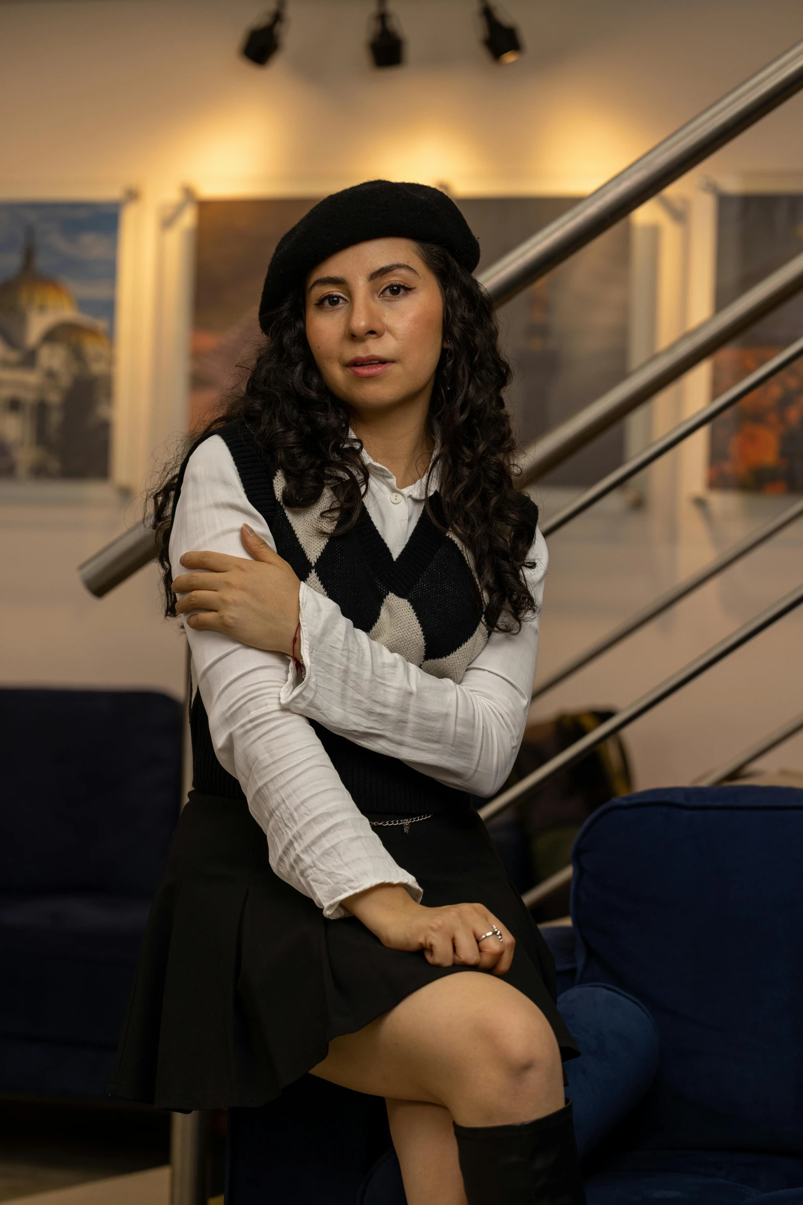 a woman is posing for a picture next to some stairs