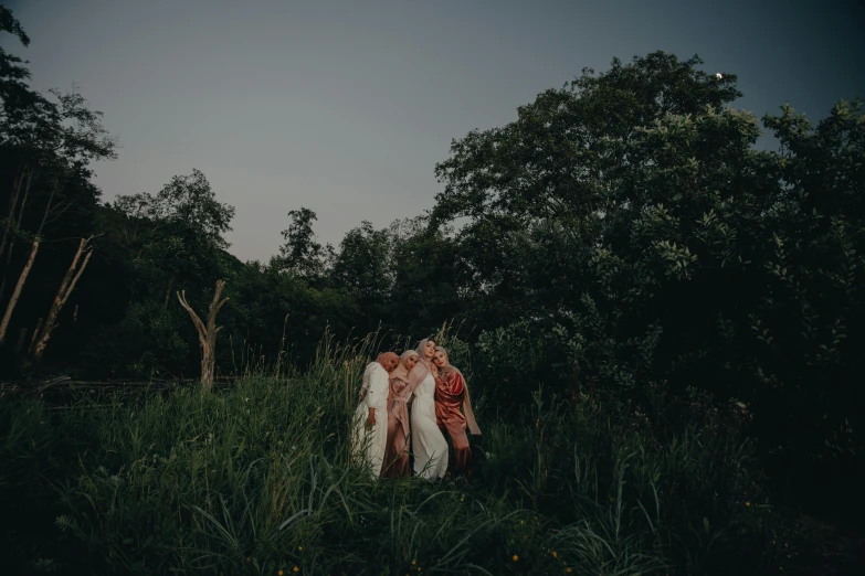 a couple of people that are standing in the grass