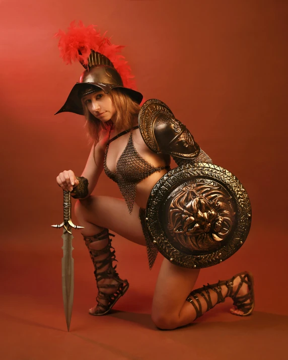 a woman dressed up as a warrior holding a sword and dagger