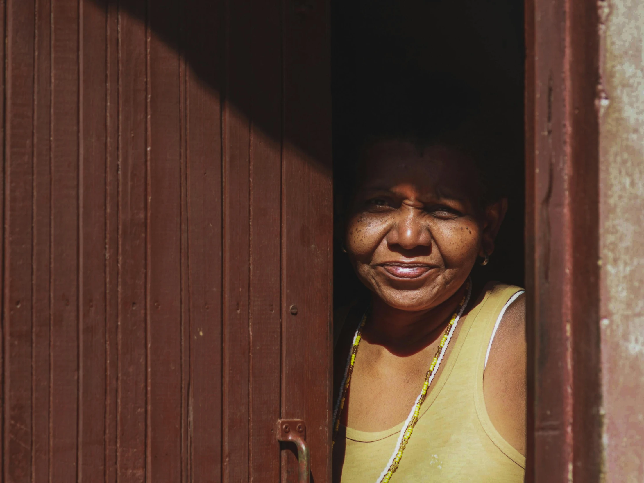 a lady that is looking out a door