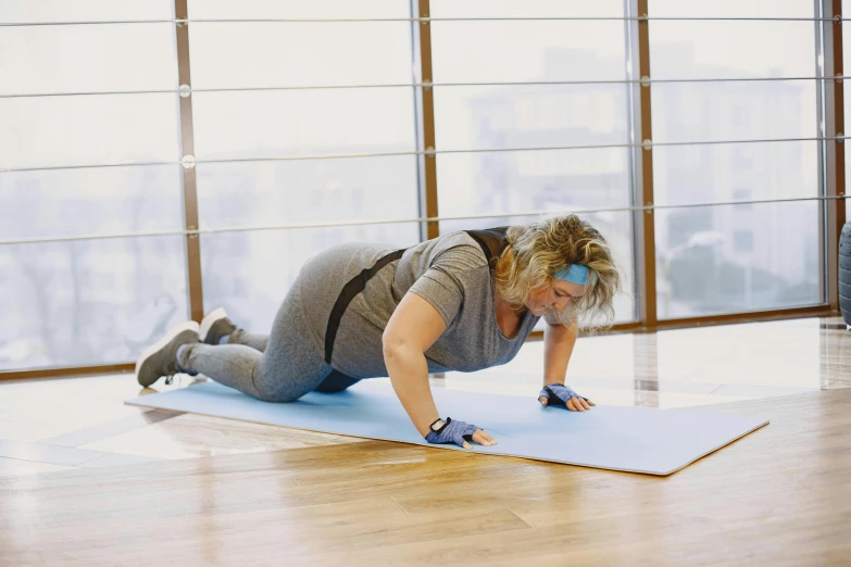 an attractive woman is in action on a yoga mat