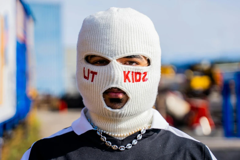 a man in a knit mask with the word s written on it