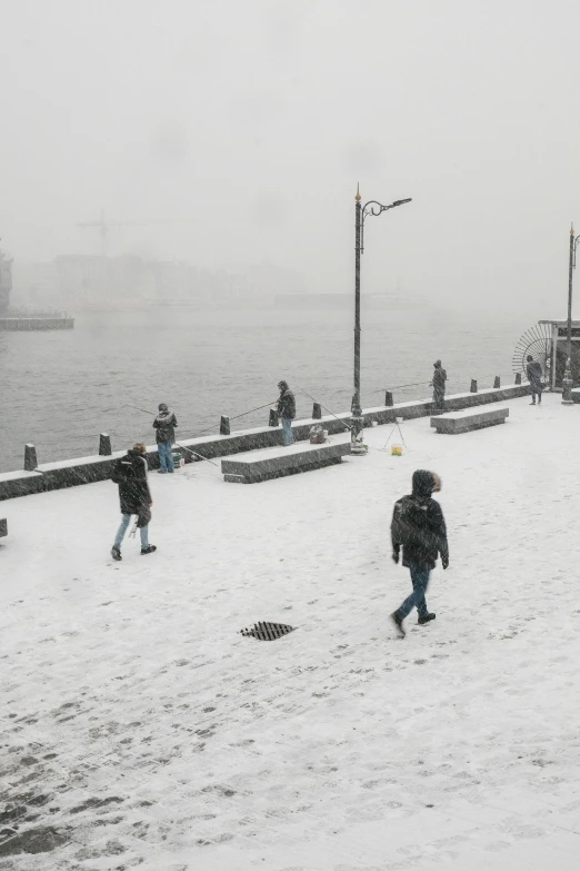 children play in the snow at a city park