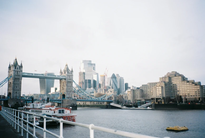 a boat is sitting on the river by the bridge