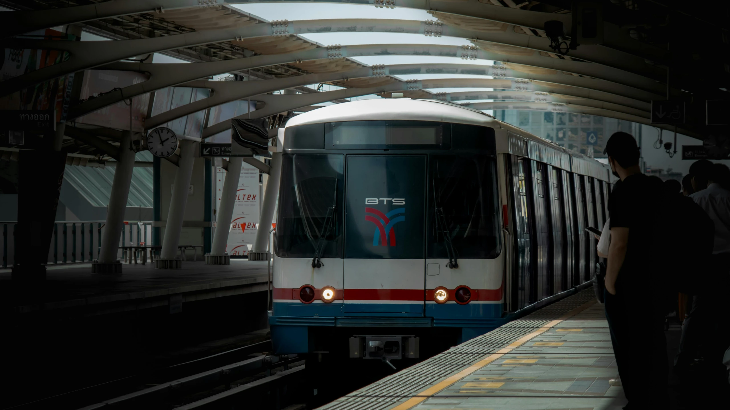 a train traveling down tracks next to a station platform