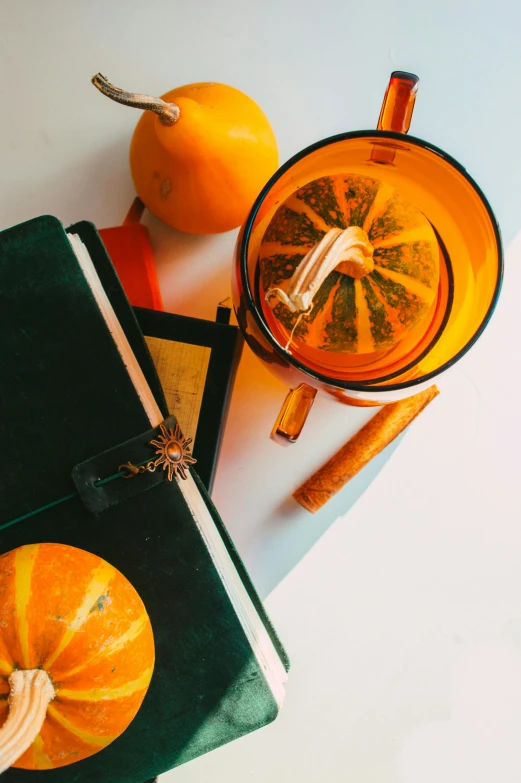 there is an orange and a juicer on the table