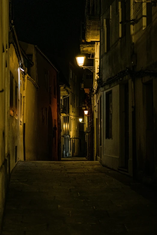 dark alleyway street at night with one light turned on