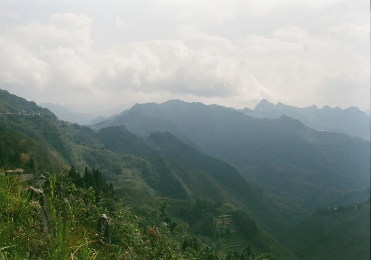 the tops of mountains in an area with grass