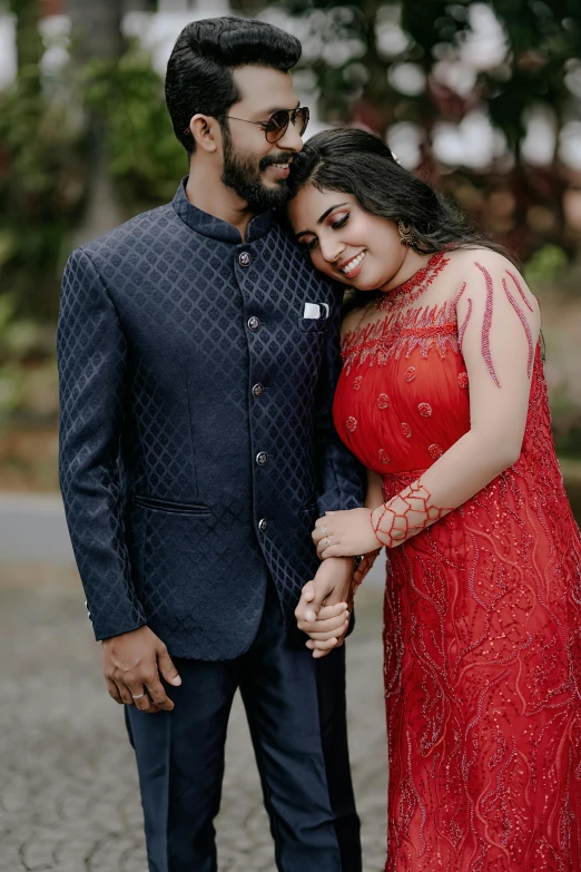 the couple is holding hands and posing for a picture