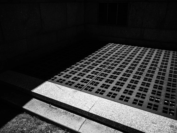 the shadows from a floor are cast onto a tiled wall