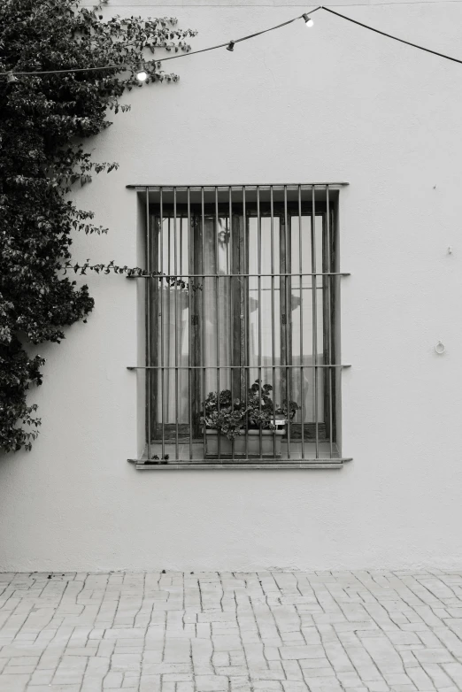 the window on the side of a building with metal bars