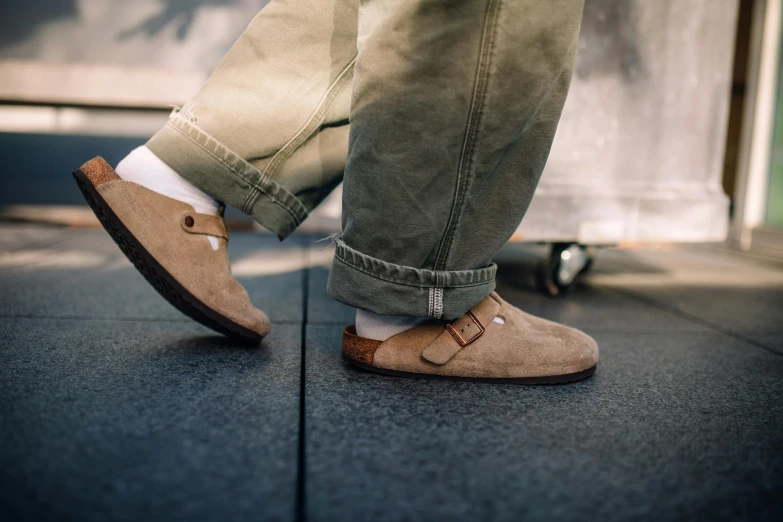 a close up of someone wearing shoes and pants