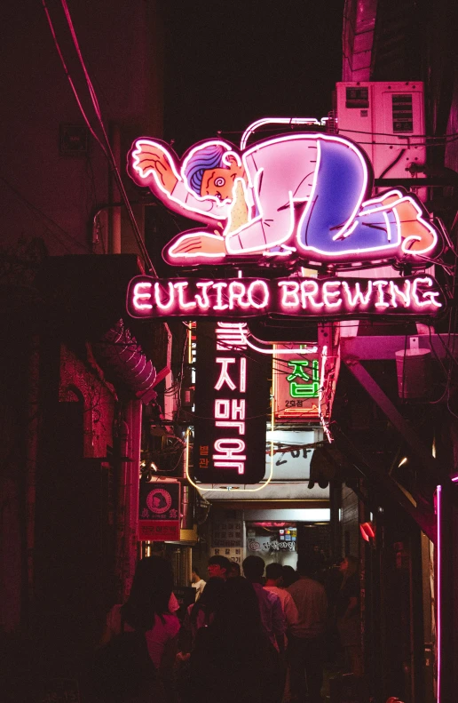 a street at night with a neon sign and advertits