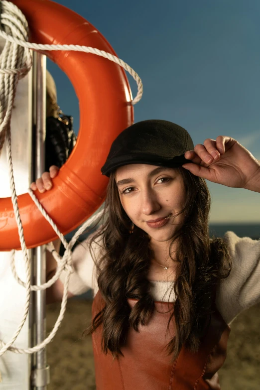 a woman is leaning against a wall and holding a life preserver