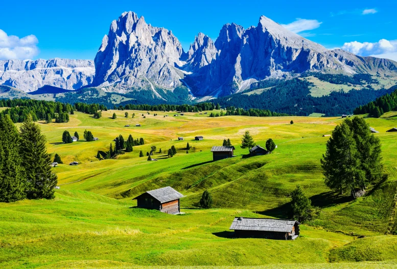 the mountains, the grass, and farm houses are very beautiful