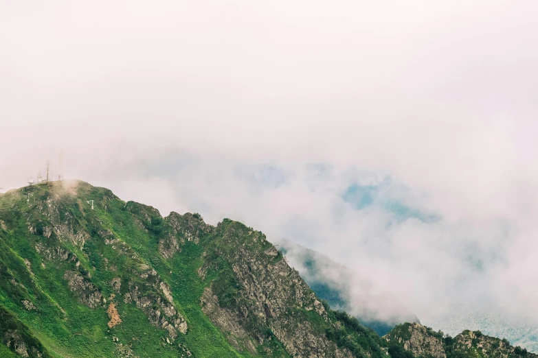 the mountains are covered with clouds in the daytime