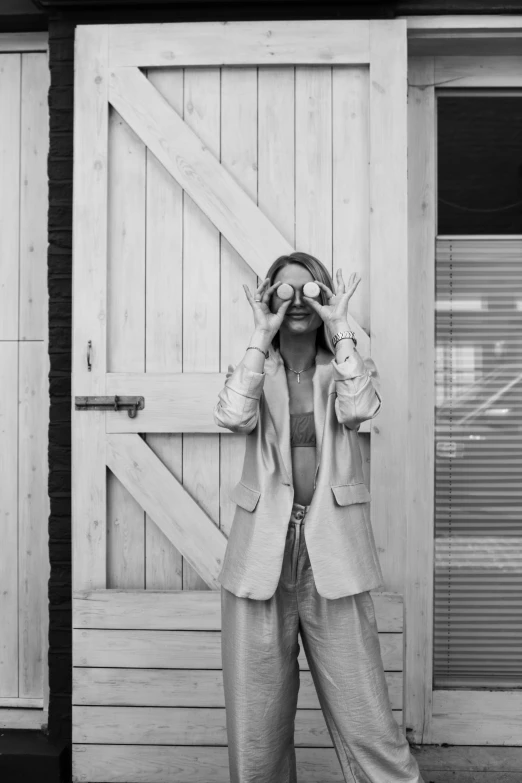 a black and white pograph of a woman covering her eyes