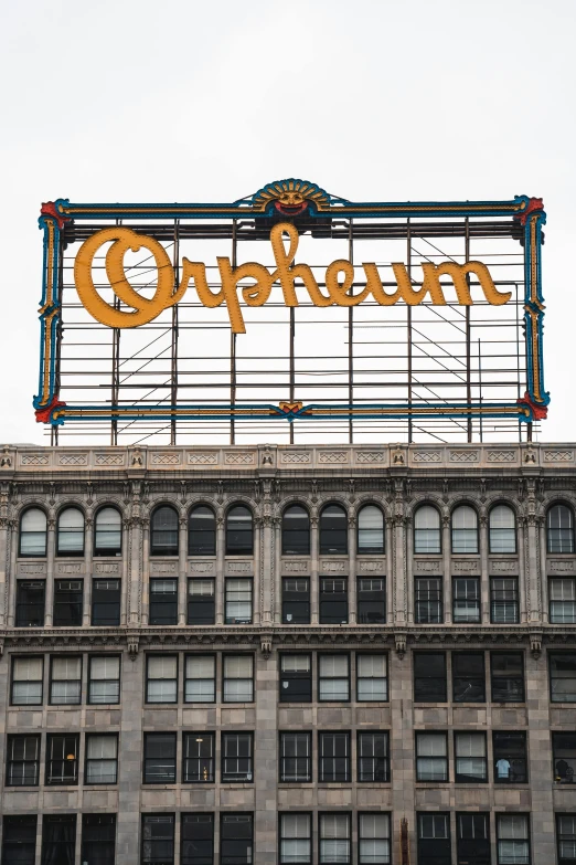 an old, faded sign in front of a tall building