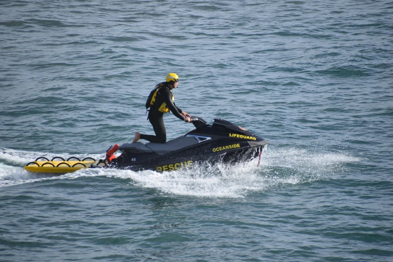 a man riding on the back of a watercraft in a body of water