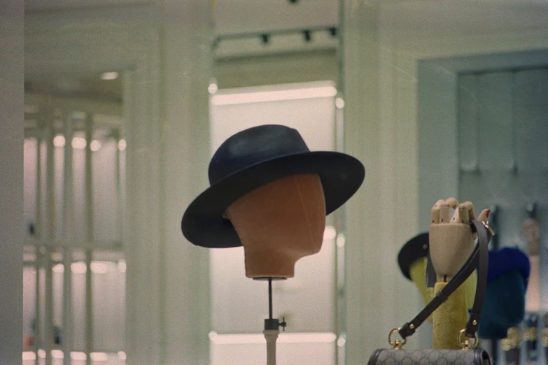 hats hanging up in the window display of a store