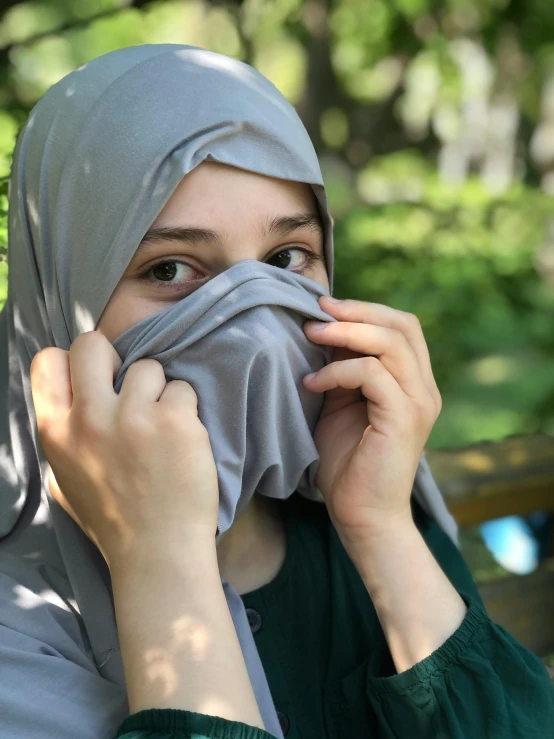 a woman holding her face next to the nose