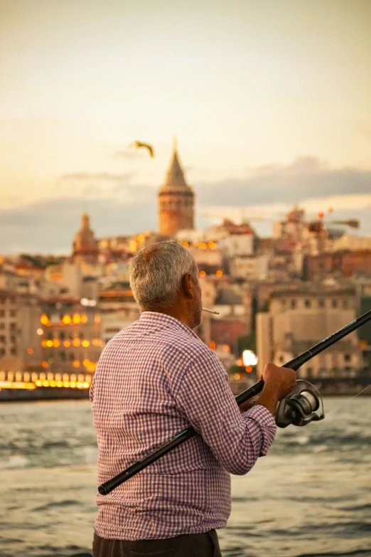 man fishing on the waterfront at dusk in croatia