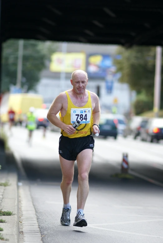 a man is running with a large sign in his hand