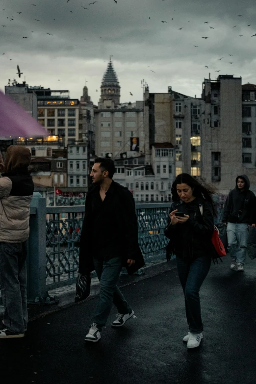 people walking in the rain and holding umbrellas