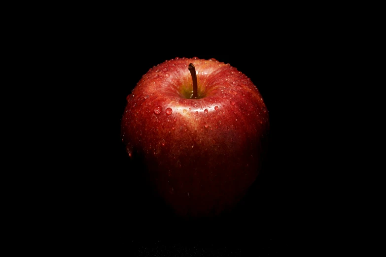 the large apple has water droplets all over it