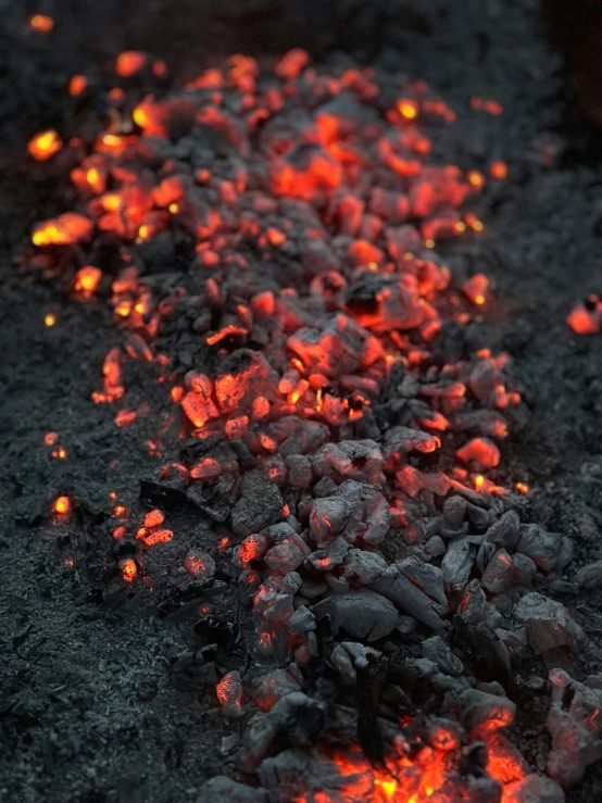 lava is lit in the dark while rocks are lavad