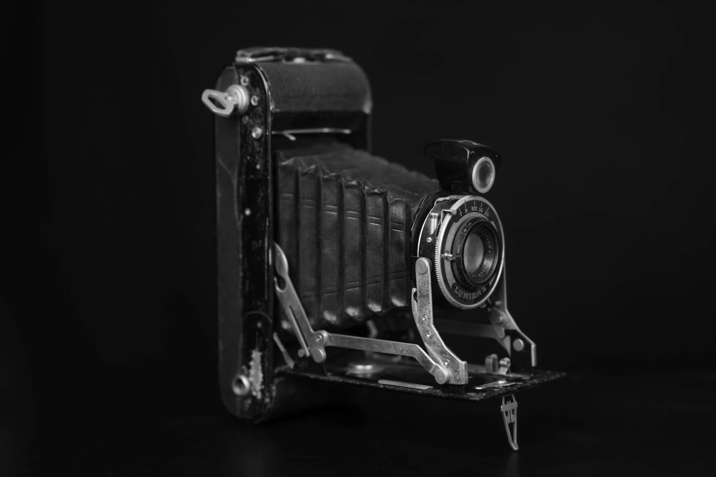 an old camera is on a small stand