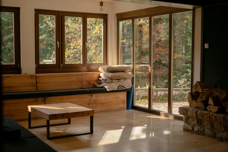 a room with windows and wooden furniture inside of it