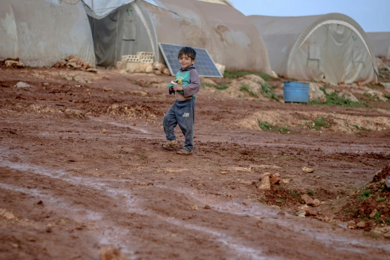 a little boy holding a ball in his hands